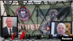 FILE - A view shows portraits of Russian mercenary chief Yevgeny Prigozhin and Wagner group commander Dmitry Utkin at a makeshift memorial in Moscow, Russia August 24, 2023.