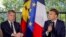 French President Emmanuel Macron, right, speaks as sits next to France's Minister for Interior and Overseas Gerald Darmanin in Noumea, New Caledonia, May 23, 2024. 