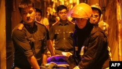 This picture taken and released by the Vietnam News Agency (VNA), Sept. 13, 2023 shows rescue workers carrying victims following a major fire at an apartment block in Hanoi. (Photo by stringer / Vietnam News Agency / AFP)