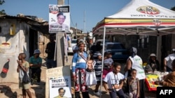 Inkatha Freedom Party (IFP) supporters stand outside the Alexandra Library polling station in Alexandra, near Johannesburg, on May 29, 2024.