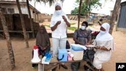 FILE - A health worker prepares to administer a cervical cancer vaccine HPV Gardasil to a girl on the street in Ibadan, Nigeria, on May 27, 2024.