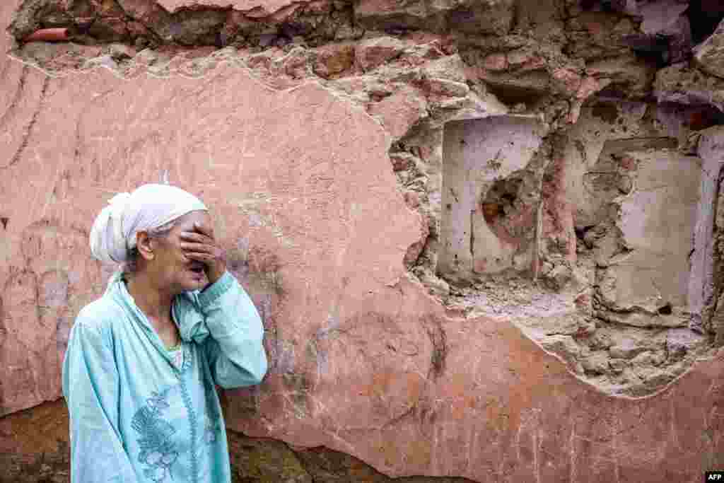 A woman reacts in front of her earthquake-damaged house in the old city in Marrakesh, Morocco, on Sept. 9, 2023.