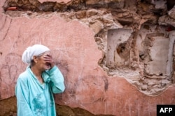 A woman reacts standing in front of her earthquake-damaged house in the old city in Marrakesh, Morocco, on Sept. 9, 2023.