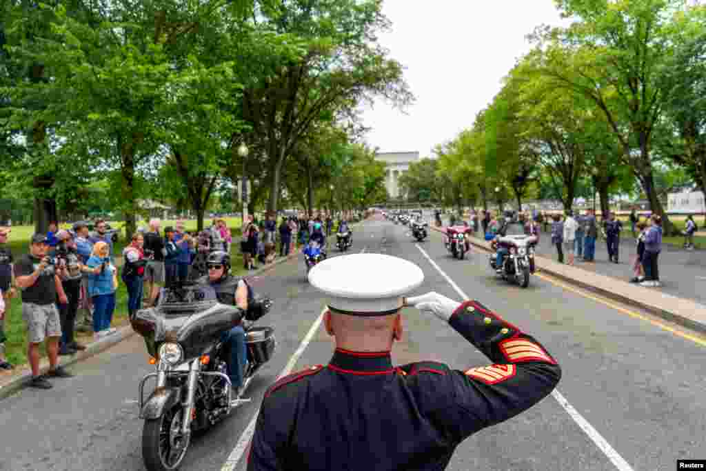 U.S. Marine Corp Staff Sgt. Tim Chambers salutes during the "Rolling to Remember" motorcycle rally, successor to "Rolling Thunder," in Washington, May 28, 2023. 