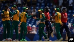 Players greet each other at the end of the ICC Men's T20 World Cup cricket match between England and South Africa at Darren Sammy National Cricket Stadium in Gros Islet, Saint Lucia, June 21, 2024. 