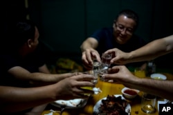 Men enjoy their time in a restaurant in Nukus, Uzbekistan, June 23, 2023.
