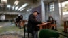 Voters fill out their ballots during elections at a polling station in Tehran, Iran, March 1, 2024. It was the country's first poll since mass protests in 2022 over mandatory hijab laws after the death in police custody of Mahsa Amini.