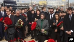 US Ambassador to Russia Lynne Tracy, center, with other ambassadors of foreign diplomatic missions, attends a laying ceremony at a makeshift memorial in front of the Crocus City Hall on the western outskirts of Moscow, March 30, 2024. 