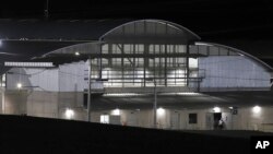 The exterior of the Terrorism Confinement Center mega-prison is illuminated during a media tour in Tecoluca, El Salvador, Feb. 2, 2023. 
