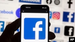 FILE - The Facebook logo is seen on a cellphone, Oct. 14, 2022, in Boston. Online platforms could face billions in fines if they don't comply with new European Union rules governing what people encounter online.