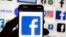 FILE - The Facebook logo is seen on a cellphone, Oct. 14, 2022, in Boston. Online platforms could face billions in fines if they don't comply with new European Union rules governing what people encounter online.