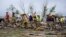 Firefighters walks among tornado-damaged homes, in Greenfield, Iowa, May 21, 2024.