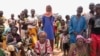 FILE - Internally displaced people wait for aid in Djibo, Burkina Faso, May 26, 2022.