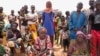 FILE - Internally displaced people wait for aid in Djibo, Burkina Faso, May 26, 2022. The OIC said it will assist Burkina Faso, Niger, Mali, Pakistan, Syria, Afghanistan, Somalia and Nigeria — the member countries with the highest death tolls from terrorism.