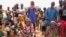 FILE - Internally displaced people wait for aid in Djibo, Burkina Faso, May 26, 2022. The OIC said it will assist Burkina Faso, Niger, Mali, Pakistan, Syria, Afghanistan, Somalia and Nigeria — the member countries with the highest death tolls from terrorism.