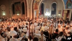 FILE: Ethiopian Orthodox Christians hold candles during the Easter religious procession, in Addis Ababa, on Sun. April 16, 2023.