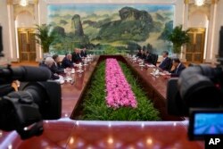 Journalists film Chinese President Xi Jinping, second right, and US Senate Majority Leader Chuck Schumer, third left, attend a bilateral meeting at the Great Hall of the People in Beijing, Oct. 9, 2023.