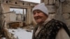 Lida, de 85 años, de pie en su apartamento del quinto piso que fue bombardeado y luego destruido por el fuego, fotografiada el 1 de abril de 2023 en Lyman, Ucrania. [Foto: Yan Boechat, VOA]