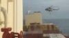 FILE - In this photo taken from video, an Iranian commando rappels from a helicopter in a raid on the MSC Aries in the Strait of Hormuz on April 13, 2024.