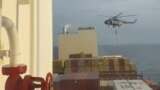 FILE - In this photo taken from video, an Iranian commando rappels from a helicopter in a raid on the MSC Aries in the Strait of Hormuz on April 13, 2024.