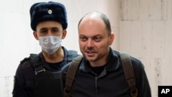 FILE - Russian opposition activist Vladimir Kara-Murza is escorted to a hearing in a court in Moscow, Feb. 8, 2023. 