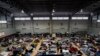 FILE - Ukrainian refugees wait in a gymnasium April 5, 2022, in Tijuana, Mexico.