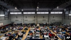 FILE - Ukrainian refugees wait in a gymnasium April 5, 2022, in Tijuana, Mexico.