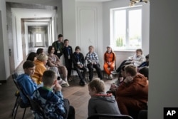 Children attend a group therapy class at the recovery camp for children and their mothers affected by the war near Lviv, Ukraine, Wednsday, May 3, 2023.