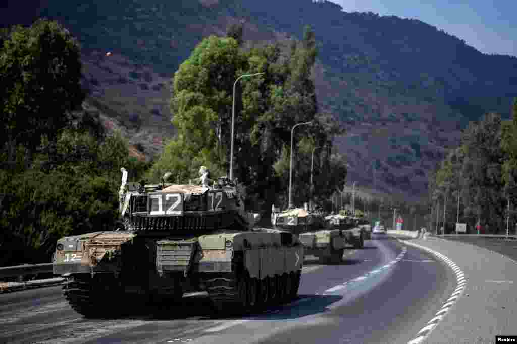 A convoy of Israeli military vehicles are seen on a road close to Israel&#39;s border with Lebanon in northern Israel, Oct. 8, 2023.