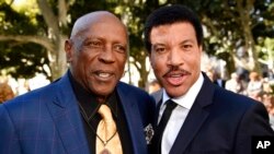 FILE - Actor Louis Gossett Jr., left, and Living Legend Award recipient Lionel Richie pose together at the opening ceremonies of the African American Heritage Month Celebration at Los Angeles City Hall, Feb. 3, 2016.