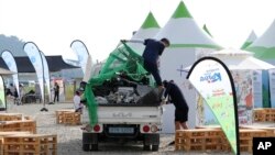 Attendees of the World Scout Jamboree prepare to leave a camping site in Buan, South Korea, Aug. 7, 2023. South Korea will evacuate tens of thousands of scouts by bus from a coastal jamboree site as Tropical Storm Khanun looms. (Newsis via AP)