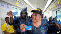 People sing as they ride on a new Lagos blue line train service in Lagos, Nigeria, Monday, Sept. 4, 2023. 