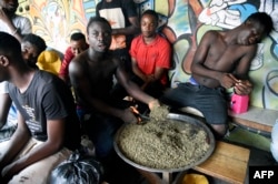 FILE - A vendor cuts cannabis popularly known as marijuana for sale in Lagos, on Nov. 11, 2019.