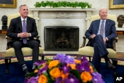 FILE - President Joe Biden, right, meets with House Speaker Kevin McCarthy to discuss the debt limit, in the Oval Office of the White House, in Washington, May 22, 2023.