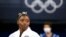 FILE - Simone Biles watches gymnasts perform after she exited the team final at the 2020 Summer Olympics, in Tokyo. Biles drew attention by pulling out of events in Tokyo because of a mental block that made her afraid to attempt certain dangerous moves. 