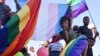 Members of Namibia's LGBT community wave rainbow flags during a Pride Parade in the capital Windhoek, July 29, 2017. The country's Supreme Court on March 20, 2023, sided with a lower court in denying a gay couple's citizenship application for their child.