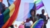 Members of Namibia's LGBTQ community wave rainbow flags during a Pride Parade in the capital Windhoek, July 29, 2017. The country's Supreme Court on March 20, 2023, sided with a lower court in denying a gay couple's citizenship application for foreign-born surrogate child.