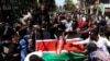 Demonstrators carry a Kenyan flag during a protest in Nairobi, Kenya, July 23, 2024. Anti-government protesters in Kenya’s capital clashed with a pro-government group on Tuesday.