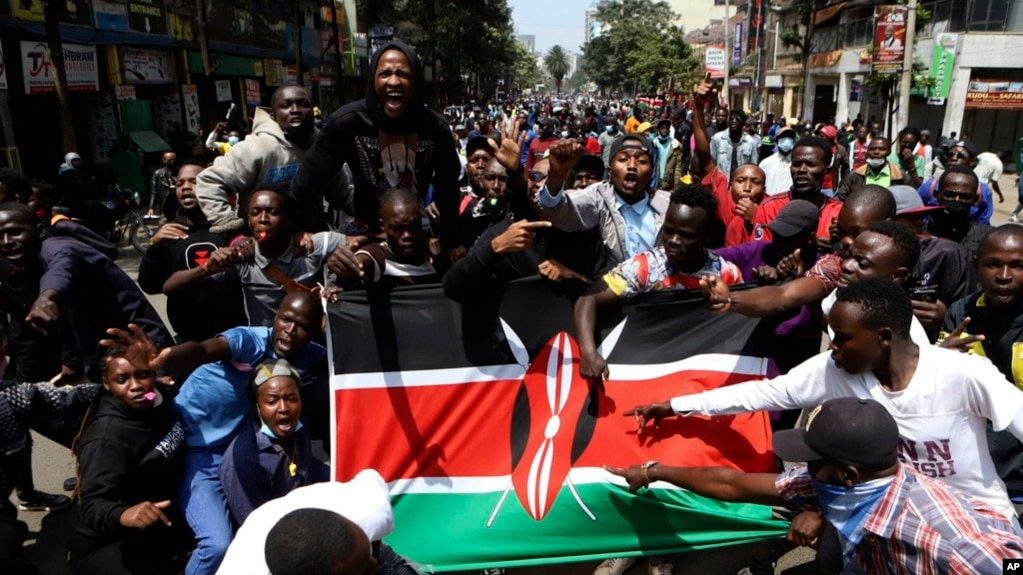 Demonstrators carry a Kenyan flag during a protest in Nairobi, Kenya, July 23, 2024. Anti-government protesters in Kenya’s capital clashed with a pro-government group on Tuesday.