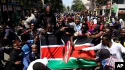 Demonstrators carry a Kenyan flag during a protest in Nairobi, Kenya, July 23, 2024