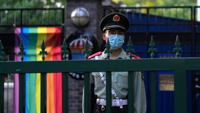 A Chinese paramilitary policeman stands guard outside the Swedish Embassy during Diversity Week in Beijing, May 12, 2023. On May 15, 2023, the advocacy group know as the Beijing LGBT Center became the latest organization to close under a government crackdown.