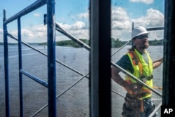 DJ Dorbert works on building scaffolding at the Hudson-Athens Lighthouse, June 12, 2024, in Hudson, New York.