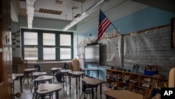 FILE - An empty elementary school classroom is seen on Aug. 17, 2021, in the Bronx borough of New York. 