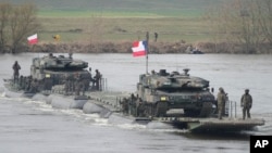 Polish and other NATO troops take part in military maneuvers Steadfast Defender 24 in Korzeniewo, Poland, on March 4, 2024, as the alliance strengthens its defense capabilities on the eastern flank in the face of Russia's war on Ukraine. (AP Photo/Czarek Sokolowski)