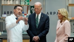 President Joe Biden and first lady Jill Biden listen during a demonstration of cancer research and detection techniques at Tulane University, Aug. 13, 2024, in New Orleans.