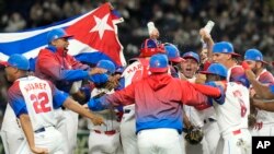 Cuban players celebrate after defeating Australia in their World Baseball Classic quarterfinal game at the Tokyo Dome in Tokyo, March 15, 2023. 