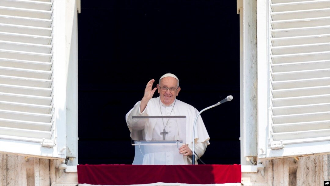 FILE - Pope Francis delivers his blessing as he recites the Angelus noon prayer from the window of his studio overlooking St. Peter's Square, at the Vatican, June 18, 2023. 