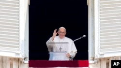 FILE - Pope Francis delivers his blessing as he recites the Angelus noon prayer from the window of his studio overlooking St. Peter's Square, at the Vatican, June 18, 2023. 