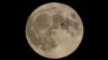 FILE - A plane passes in front of the moon, Aug. 30, 2023, in Chicago, Illinois.