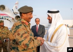 FILE - Sheikh Mohamed bin Zayed Al Nahyan, who was then crown prince of Abu Dhabi, right, receives then-Lieutenant General Abdel Fattah al-Burhan of Sudan at the Presidential Airport in Abu Dhabi, UAE, May 26, 2019. (Ministry of Presidential Affairs/AP)